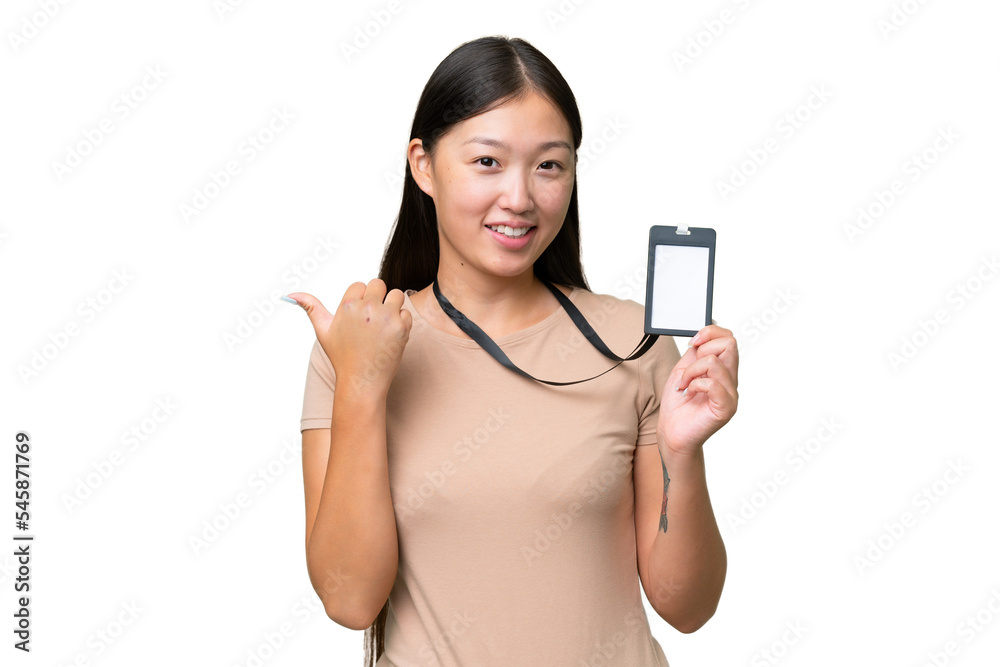 Young Asian woman with ID card over isolated background pointing to the side to present a product Young Asian woman with ID card over isolated background pointing to the side to present a product