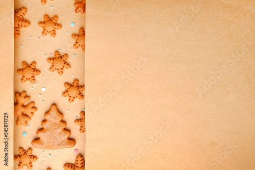 Gingerbread Christmas cakes without decorations in the form of snowflakes and Christmas trees on craft paper.Happy eco-friendly Christmas, preparation for Christmas Eve, a recipe for holiday cookies.
