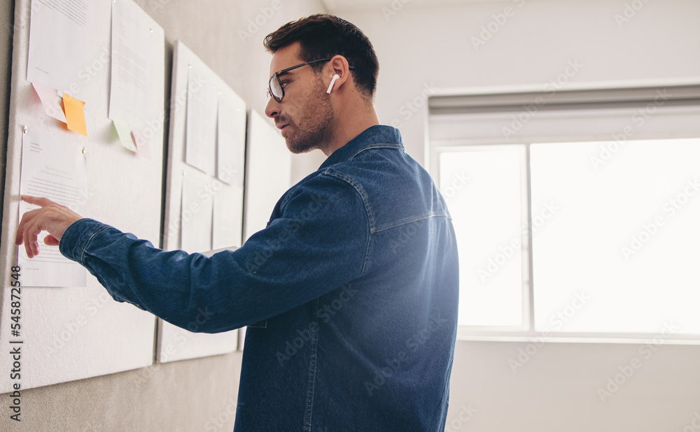 Businessman reading a report during a virtual meeting Businessman reading a report during a virtual meeting