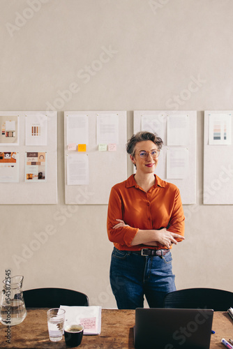 Happy female designer smiling at the camera in her office