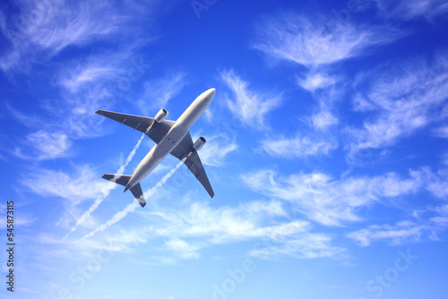 Horizontal nature background with aircraft and Jet trailing smoke in the sky. Airplane and condensation trail