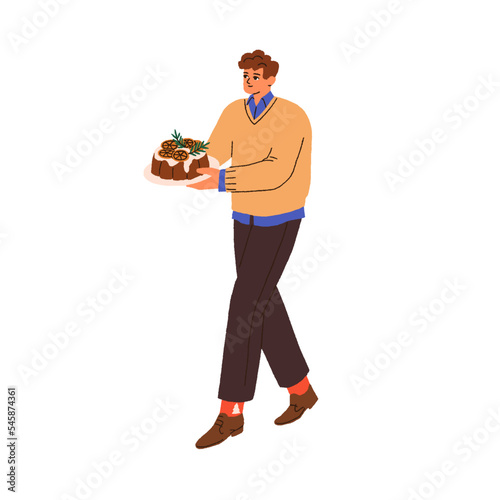 Man carrying Christmas chocolate pudding. Person holding homemade dessert, tr...