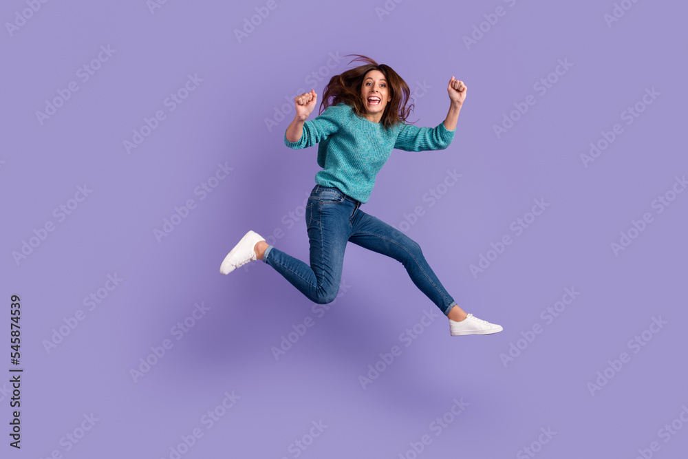 Full body photo of young excited woman celebrate victory fists hands awesome luck isolated over violet color background