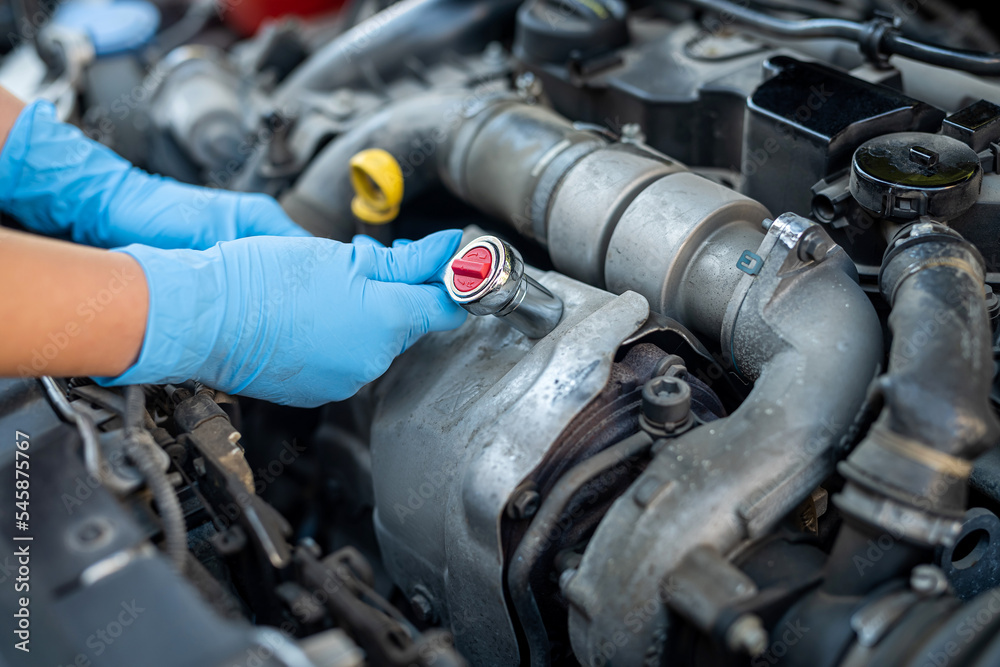 Fototapeta premium Male mechanic help woman solve the problem of car breakdown.