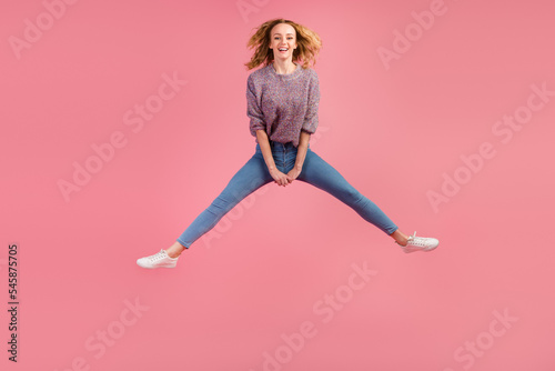 Full size view of nice lovely wavy-haired girl jumping having fun isolated on pastel color background