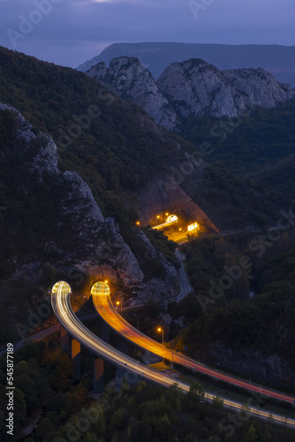 Car lights on the highway between mountains