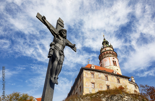 Czech Republic, South Bohemian Region, Cesky Krumlov, Sculpture of crucified Jesus with Cesky Krumlov Castle photo