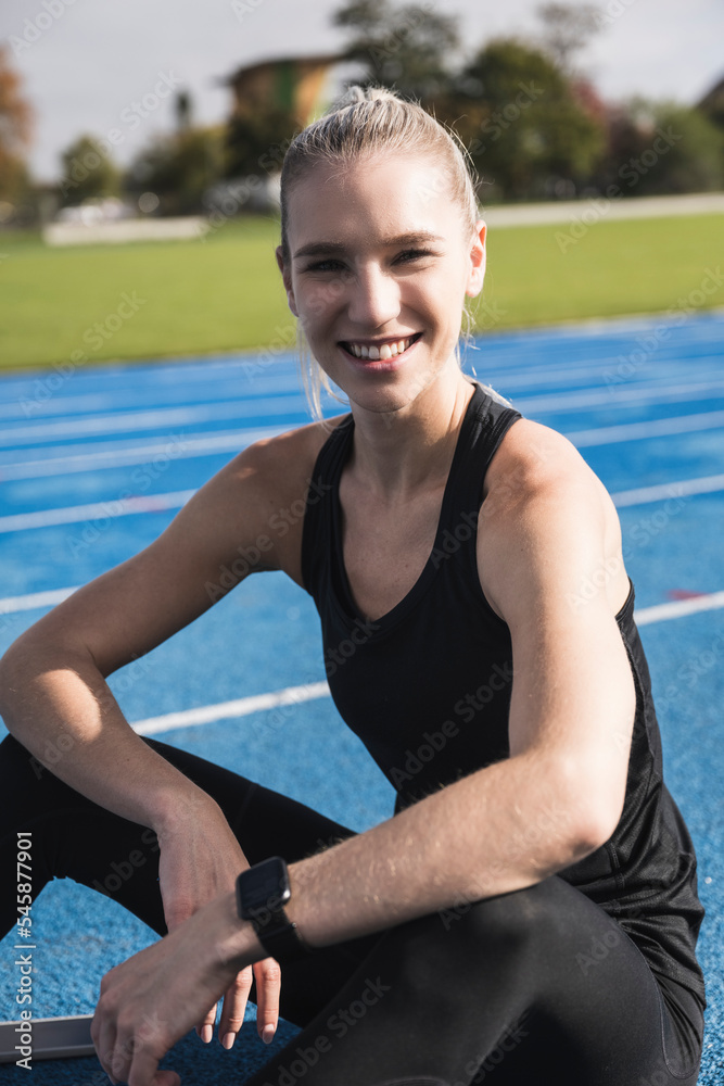 Smiling young sportswoman on running track Smiling young sportswoman on running track
