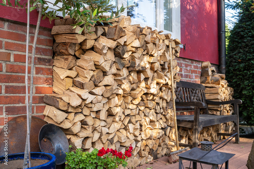 Stack of firewood stored in back yard photo