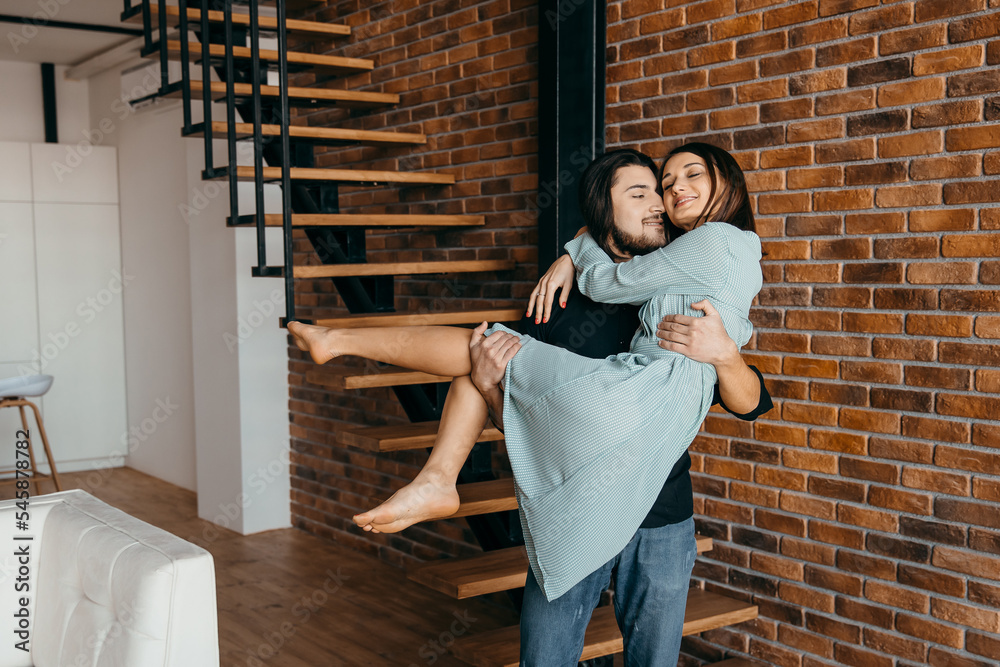 Husband holds his beloved wife in his arms Husband holds his beloved wife in his arms