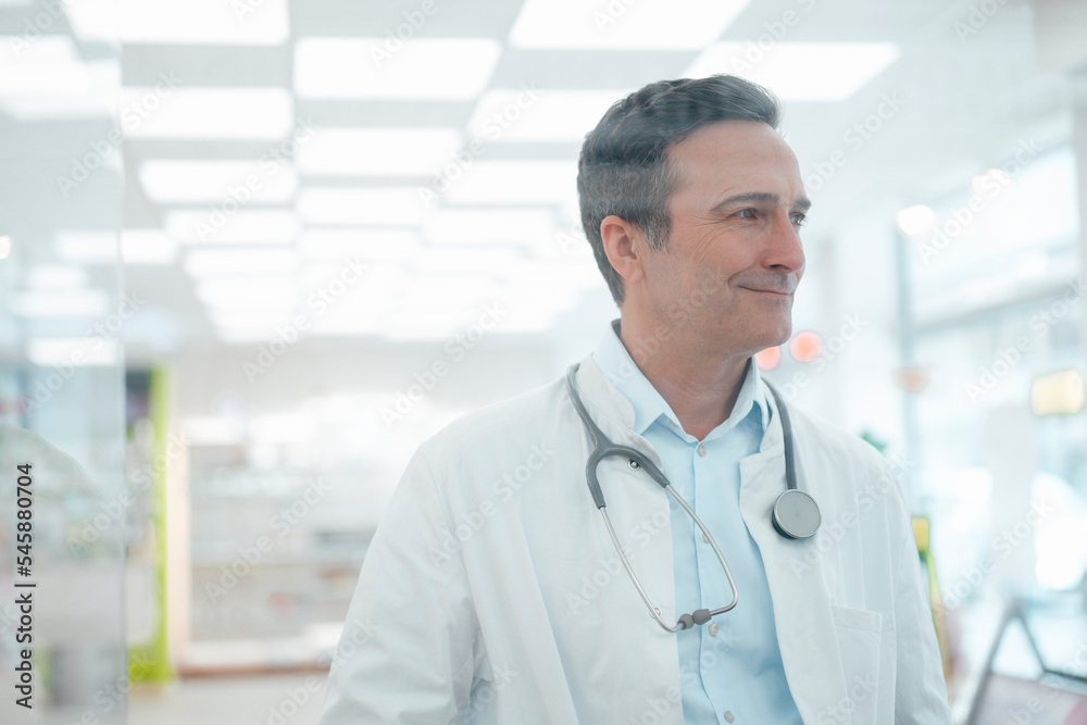 Smiling doctor with stethoscope seen through glass Smiling doctor with stethoscope seen through glass
