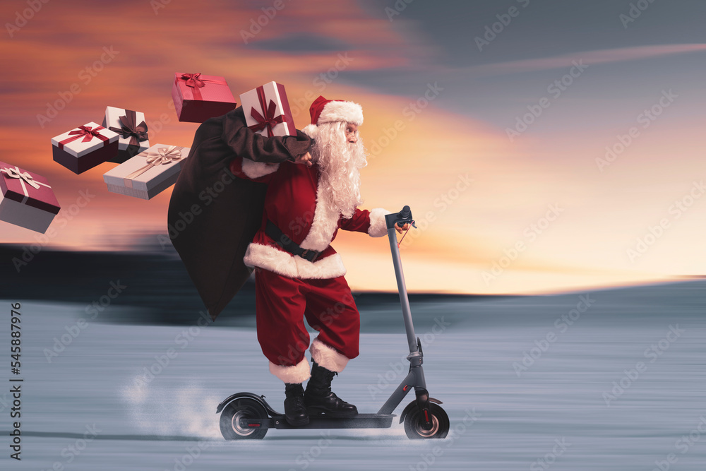 Fototapeta premium Santa Claus riding a scooter and delivering gifts
