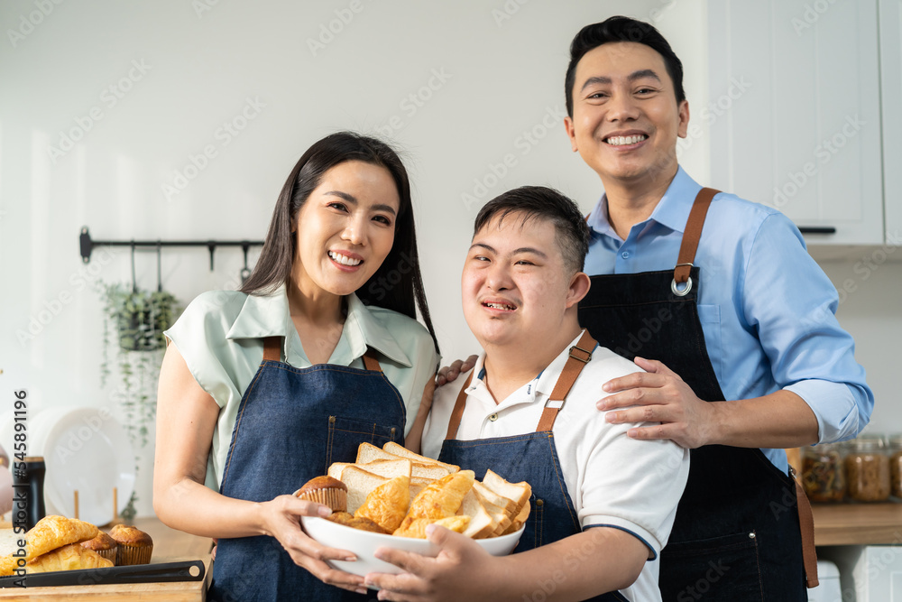 Asian happy family, mature parents baking bakery with son in kitchen. Asian happy family, mature parents baking bakery with son in kitchen.