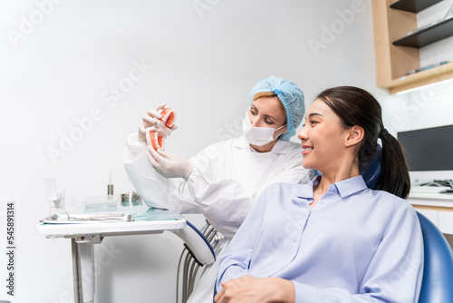 Caucasian dentist examine tooth for young girl at dental health clinic. 