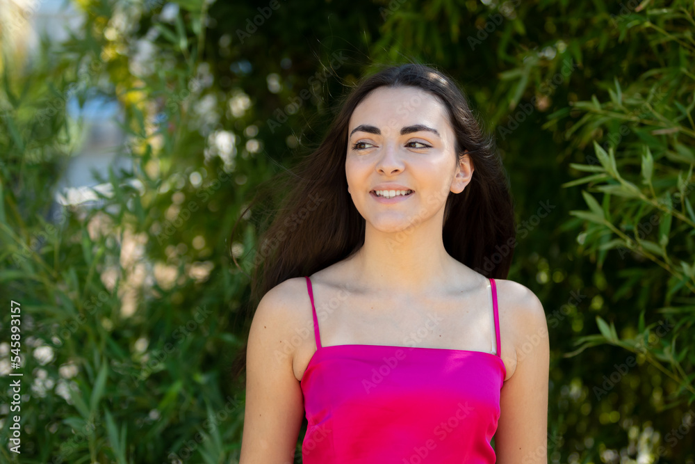 Portrait of a happy lovely and beautiful Spanish young woman in a park. Portrait of a happy lovely and beautiful Spanish young woman in a park.