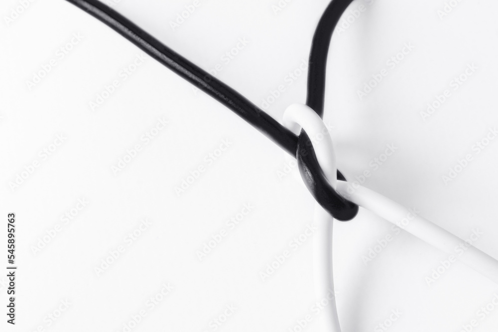 black and white cord tied in a knot in a symbol of tolerance with space for text on a white background black and white cord tied in a knot in a symbol of tolerance with space for text on a white background
