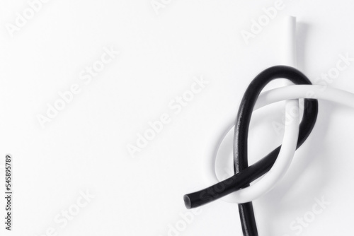 black and white cord tied in a knot in a symbol of tolerance with space for text on a white background