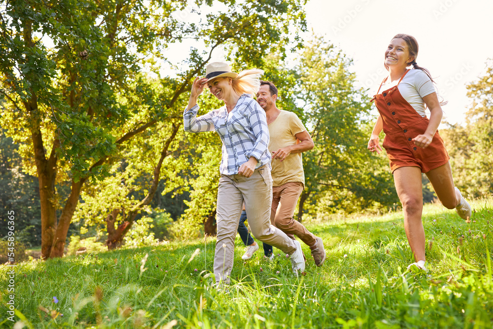 Fototapeta premium Happy family running across a meadow