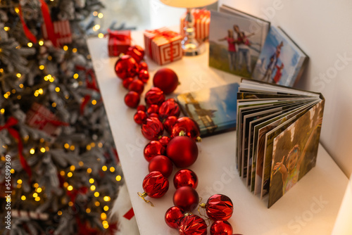 travel photo books lie near the Christmas tree