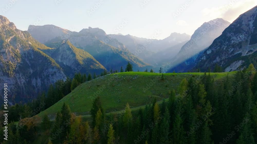 Hazy sunrays shining across Karwendel park forested mountains, Austria aerial view moving forward Hazy sunrays shining across Karwendel park forested mountains, Austria aerial view moving forward