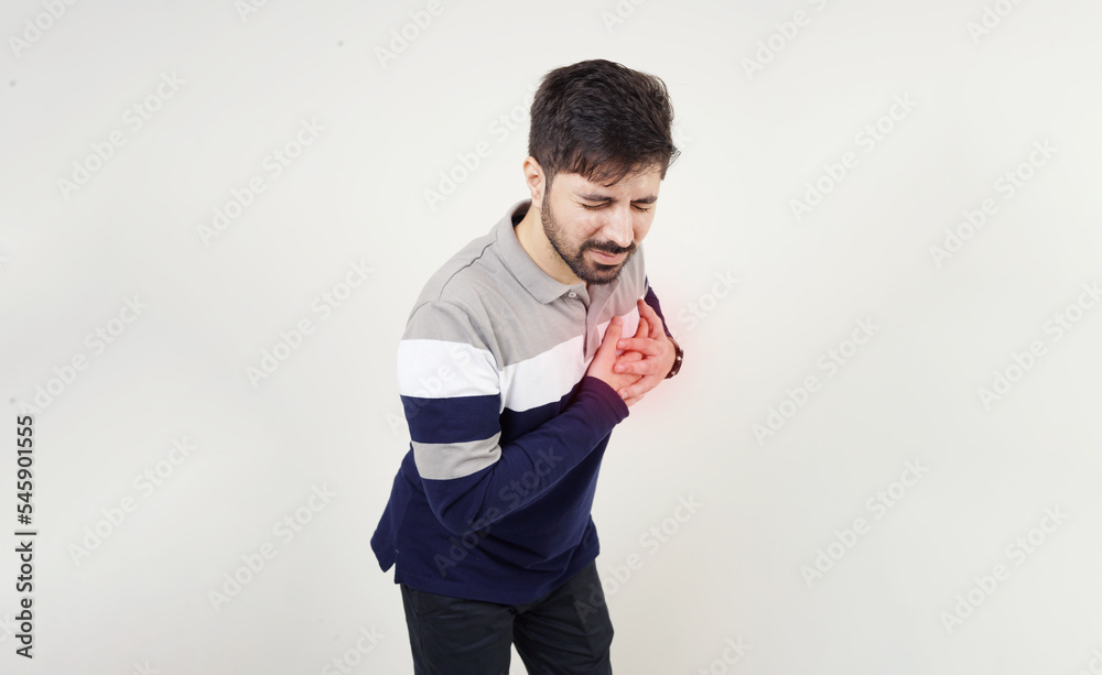 Young man having heart attack. Guy having pain in the heart. Painful expression of a man holding