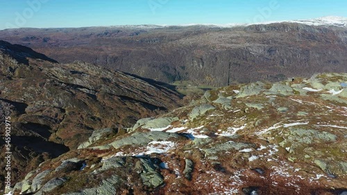 Aerial flying above landscape photographer on mountaintop before revealing majestic Nesheim and Eksingedalen valley in Norway photo