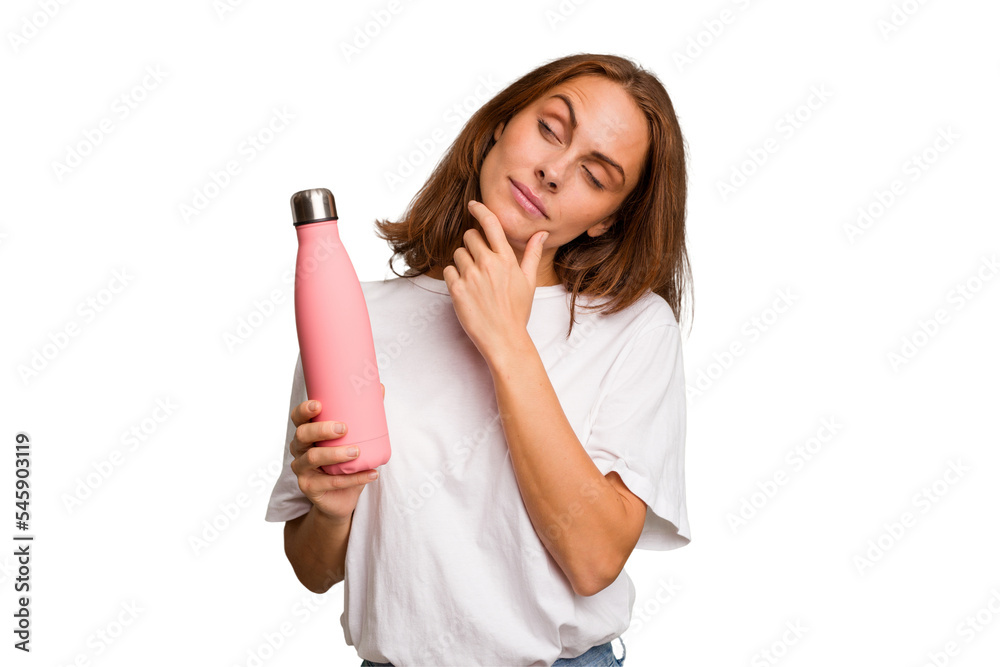 Young caucasian woman holding a pink thermo isolated looking sideways with doubtful and skeptical expression. Young caucasian woman holding a pink thermo isolated looking sideways with doubtful and skeptical expression.