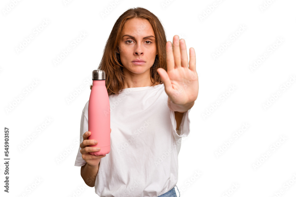 Young caucasian woman holding a pink thermo isolated standing with outstretched hand showing stop sign, preventing you.