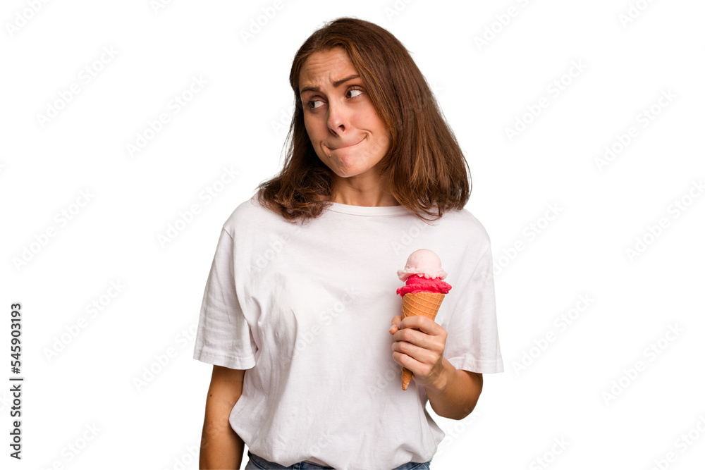 Young caucasian woman holding an ice cream isolated confused, feels doubtful and unsure. Young caucasian woman holding an ice cream isolated confused, feels doubtful and unsure.