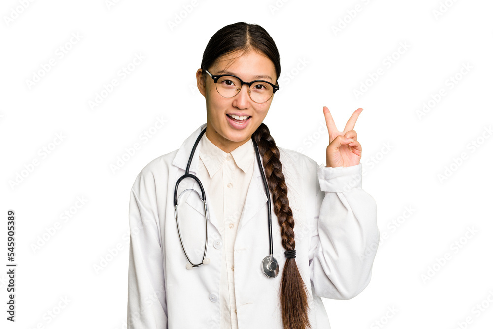Young doctor asian woman isolated joyful and carefree showing a peace symbol with fingers. Young doctor asian woman isolated joyful and carefree showing a peace symbol with fingers.
