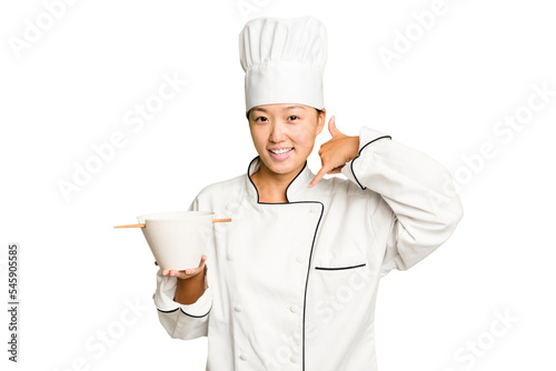 Young chef asian woman holding a bowl of ramen isolated showing a mobile phone call gesture with fingers.