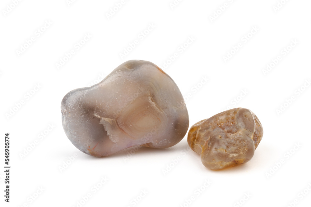 Multicolored gemstones, tumbled minerals. Bostwan agate of various sizes on a white background. Multicolored gemstones, tumbled minerals. Bostwan agate of various sizes on a white background.