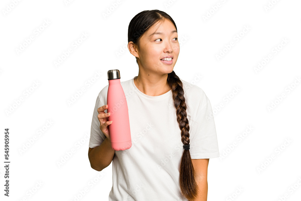 Young asian woman holding a pink thermo isolated looks aside smiling, cheerful and pleasant. Young asian woman holding a pink thermo isolated looks aside smiling, cheerful and pleasant.