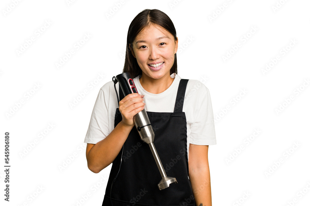 Young asian cook woman holding a blender isolated happy, smiling and cheerful. Young asian cook woman holding a blender isolated happy, smiling and cheerful.
