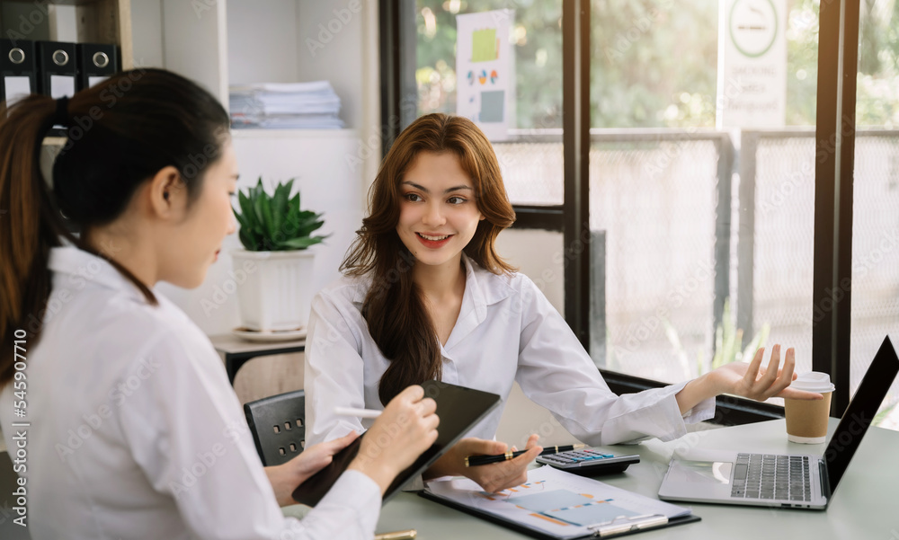 Asian young women business people discussing on performance revenue in meeting.