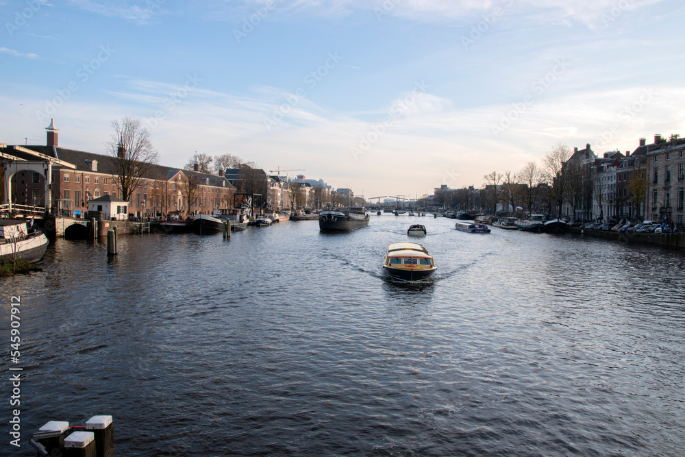 Boats On The Amstel Seen From The Blauwbrug Bridge At Amsterdam The Netherlands 2019Boats On The Amstel Seen From The Blauwbrug Bridge At Amsterdam The Netherlands 2019
