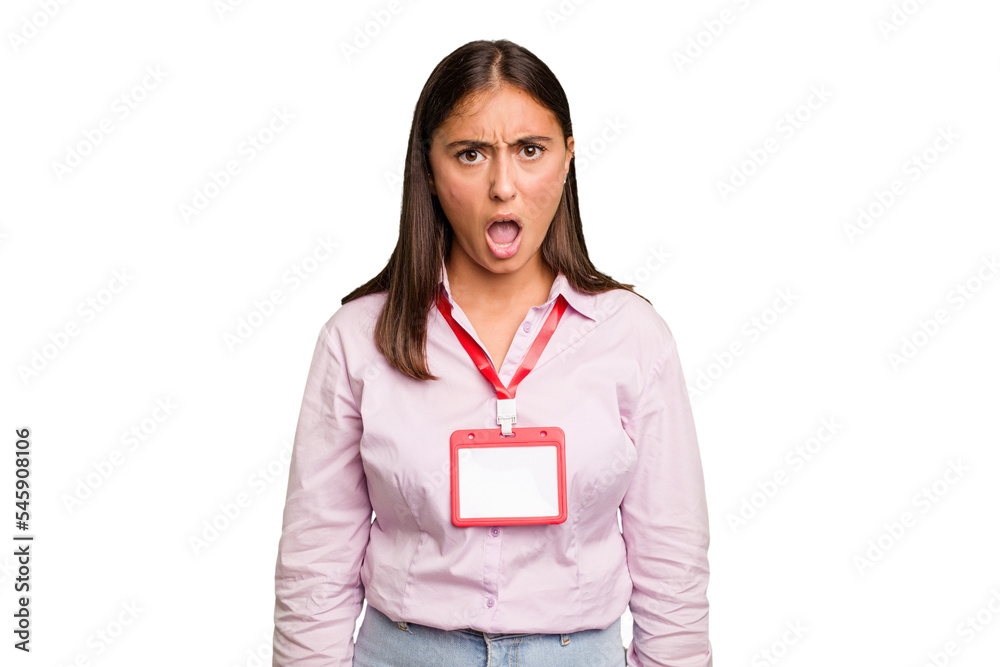 Young caucasian woman with a badge isolated screaming very angry and aggressive. Young caucasian woman with a badge isolated screaming very angry and aggressive.