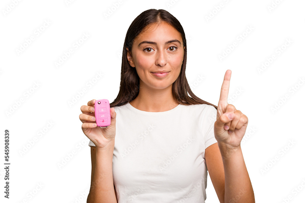 Young caucasian woman holding a car keys isolated showing number one with finger. Young caucasian woman holding a car keys isolated showing number one with finger.