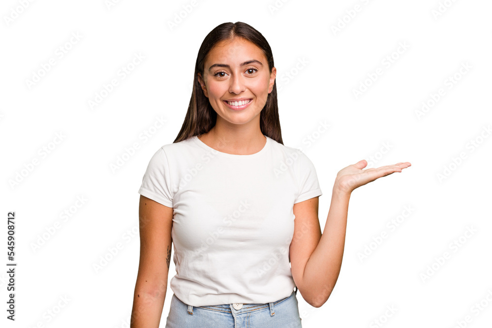 Young cute caucasian woman isolated showing a copy space on a palm and holding another hand on waist. Young cute caucasian woman isolated showing a copy space on a palm and holding another hand on waist.