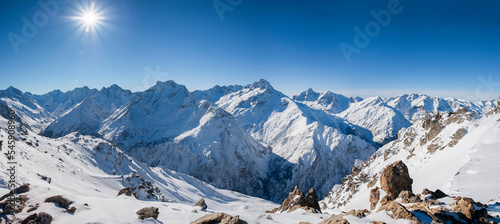 Sunshine in the French Alps with snow-covered peaks, panoramic landscape in winter © DGPhotography