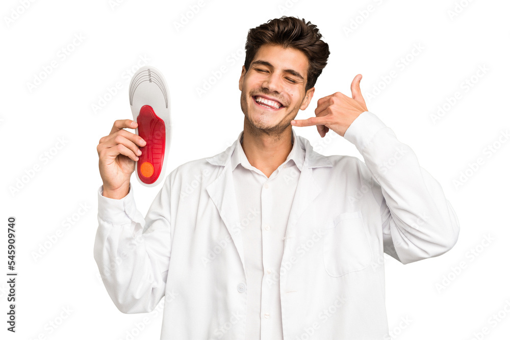 Young caucasian chiropodist man isolated showing a mobile phone call gesture with fingers. Young caucasian chiropodist man isolated showing a mobile phone call gesture with fingers.