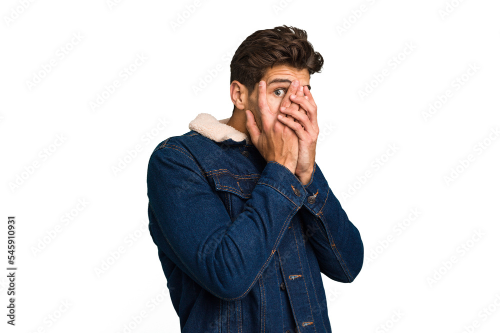Young caucasian handsome man isolated blink through fingers frightened and nervous. Young caucasian handsome man isolated blink through fingers frightened and nervous.