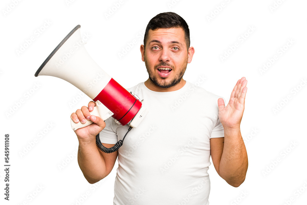 Young caucasian man holding a megaphone isolated surprised and shocked. Young caucasian man holding a megaphone isolated surprised and shocked.