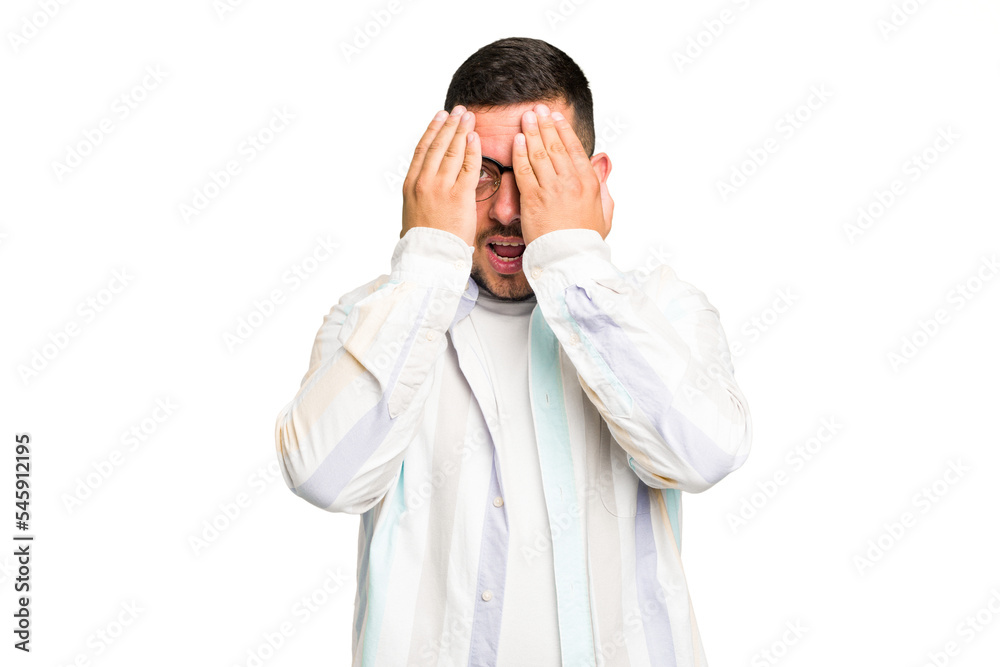 Young caucasian man isolated having fun covering half of face with palm. Young caucasian man isolated having fun covering half of face with palm.
