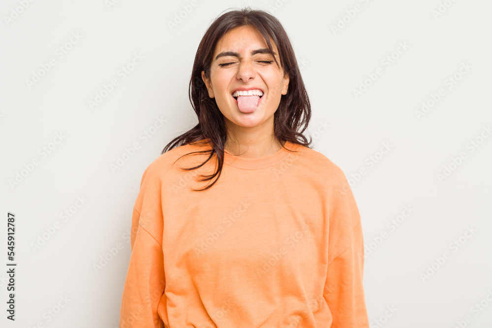 Young Indian woman isolated on white background funny and friendly sticking out tongue. Young Indian woman isolated on white background funny and friendly sticking out tongue.