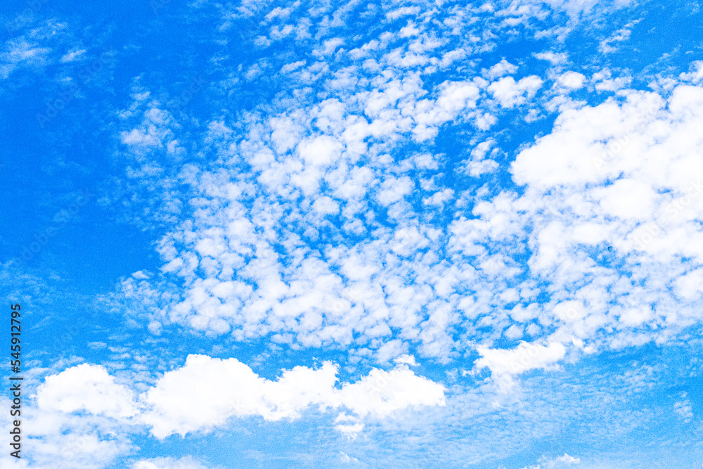 Fototapeta premium Azure Dreams: The Magic of White Clouds in the Summer Sky