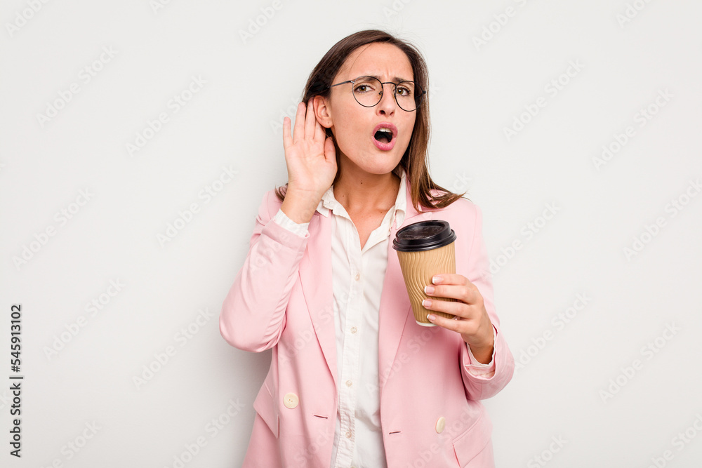 Business caucasian woman holding a take away coffee isolated on white background trying to listening a gossip. Business caucasian woman holding a take away coffee isolated on white background trying to listening a gossip.