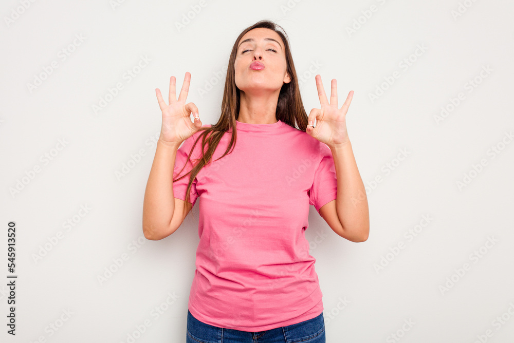 Young caucasian cute woman isolated on white background relaxes after hard working day, she is performing yoga. Young caucasian cute woman isolated on white background relaxes after hard working day, she is performing yoga.