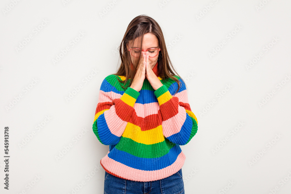 Young caucasian cute woman isolated on white background praying, showing devotion, religious person looking for divine inspiration. Young caucasian cute woman isolated on white background praying, showing devotion, religious person looking for divine inspiration.