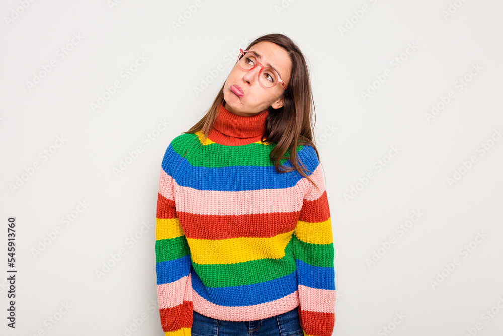 Young caucasian cute woman isolated on white background shrugs shoulders and open eyes confused. Young caucasian cute woman isolated on white background shrugs shoulders and open eyes confused.
